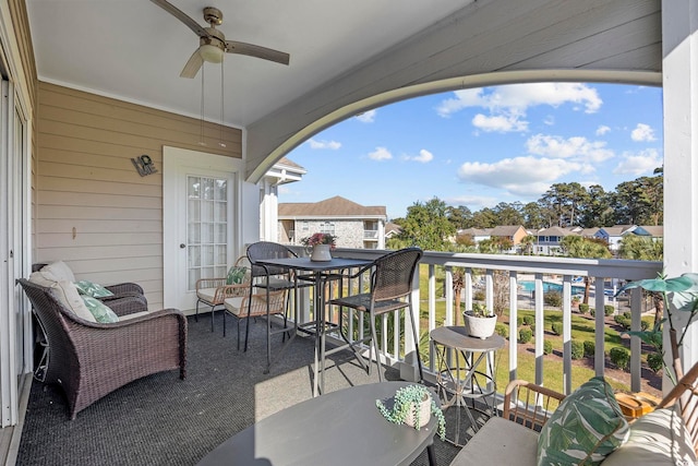 balcony featuring a residential view and a ceiling fan