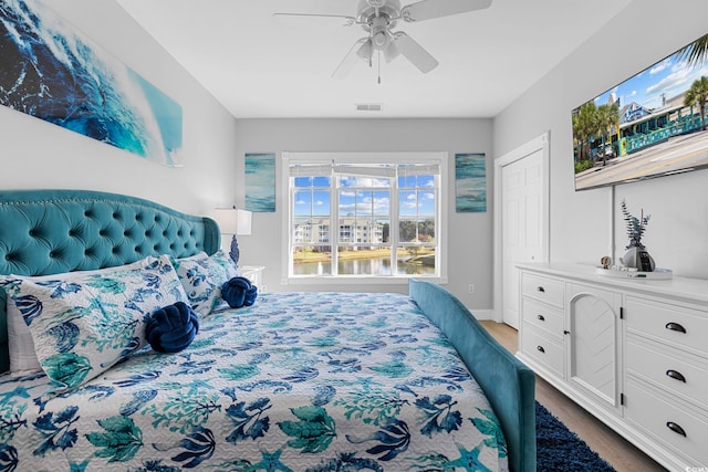 bedroom with ceiling fan and hardwood / wood-style floors