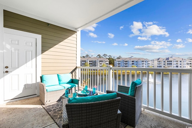 balcony with a water view and an outdoor hangout area