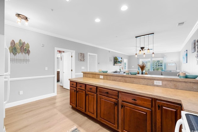 kitchen with ornamental molding, range, decorative light fixtures, and light wood-type flooring