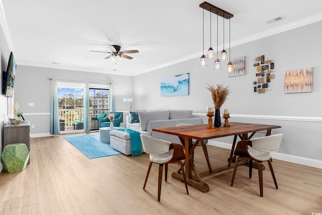 dining area featuring ornamental molding, light hardwood / wood-style floors, and ceiling fan