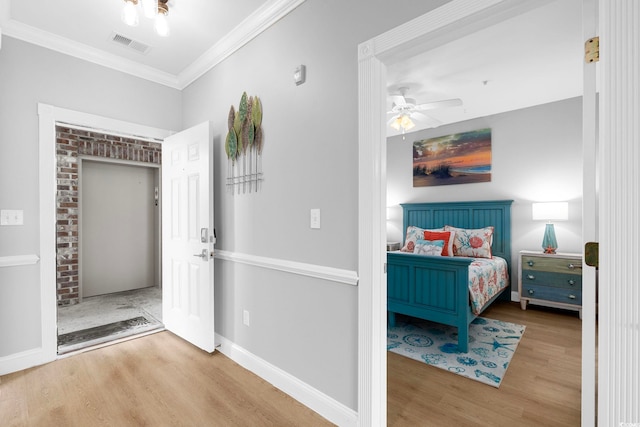 bedroom featuring ornamental molding, hardwood / wood-style flooring, and ceiling fan