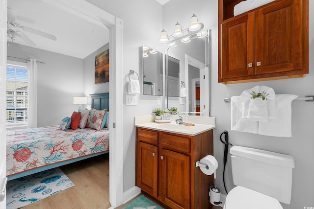 bathroom with vanity, toilet, ceiling fan, and hardwood / wood-style floors