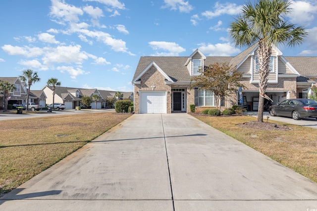 view of front of house with a front yard and a garage