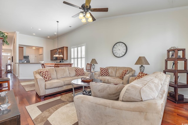 living room featuring dark hardwood / wood-style floors, ceiling fan, ornamental molding, and lofted ceiling