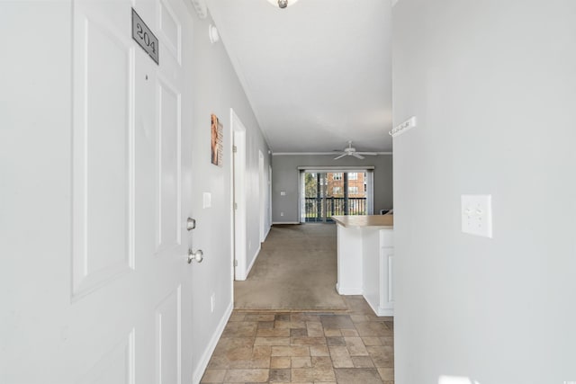 corridor featuring crown molding and light colored carpet