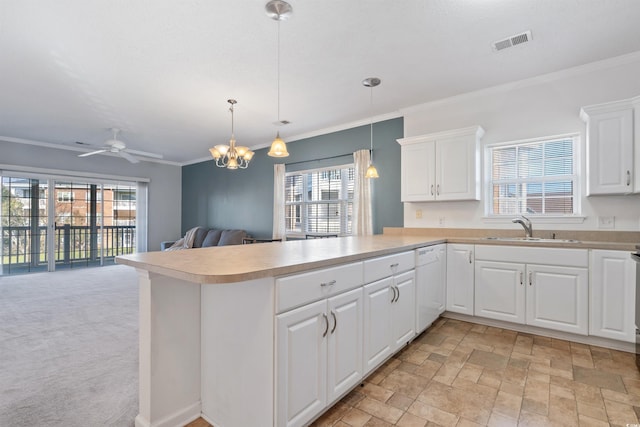 kitchen featuring dishwasher, kitchen peninsula, sink, decorative light fixtures, and white cabinetry