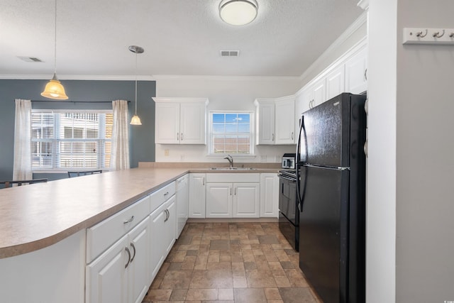 kitchen featuring sink, black appliances, decorative light fixtures, and plenty of natural light