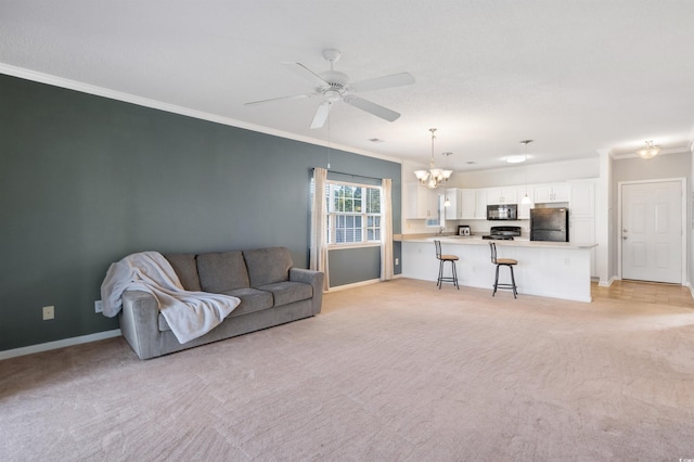 living room featuring ceiling fan with notable chandelier, ornamental molding, and light colored carpet