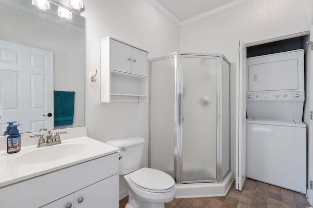 bathroom with a shower with door, toilet, stacked washing maching and dryer, crown molding, and vanity