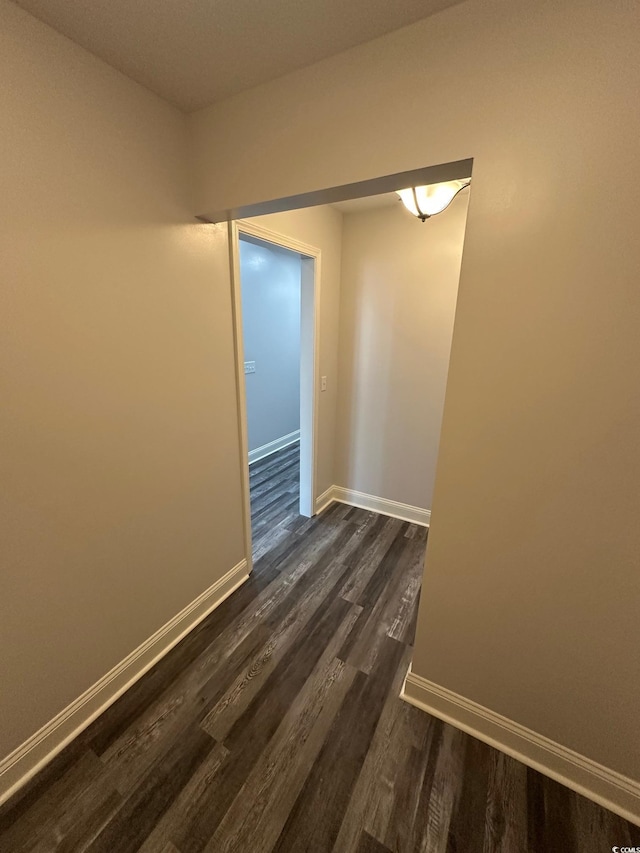 empty room with dark wood-type flooring