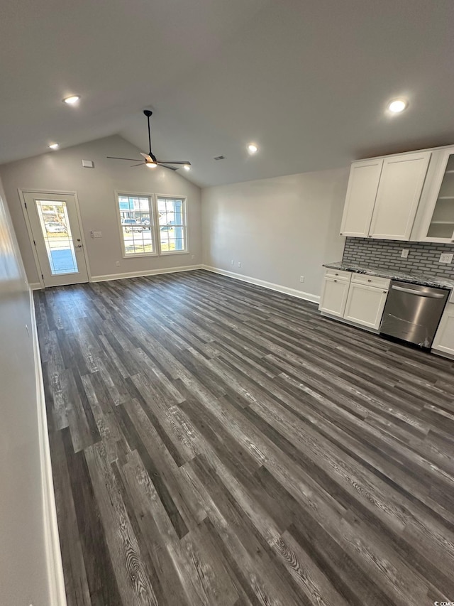 unfurnished living room with dark hardwood / wood-style floors, ceiling fan, and vaulted ceiling