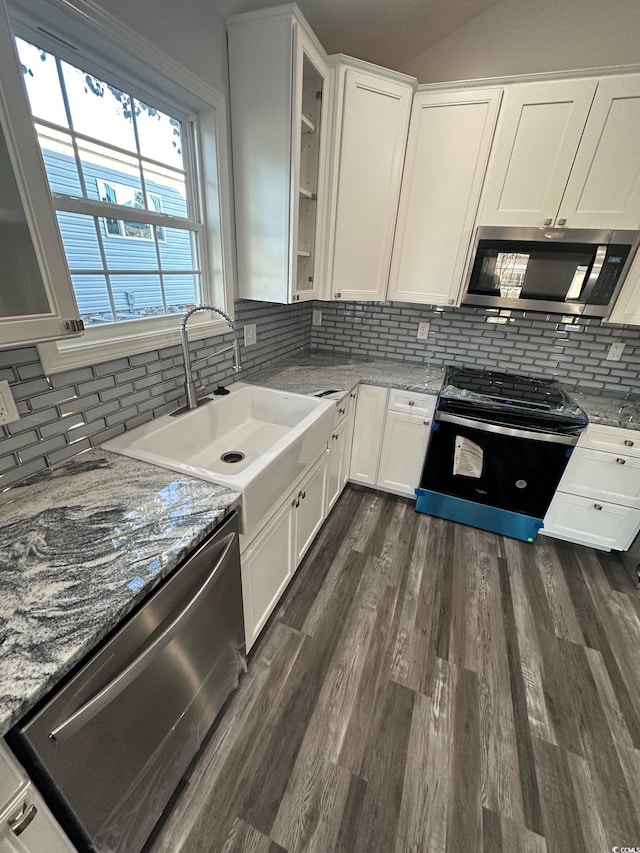 kitchen with white cabinetry, sink, stainless steel appliances, tasteful backsplash, and dark hardwood / wood-style floors