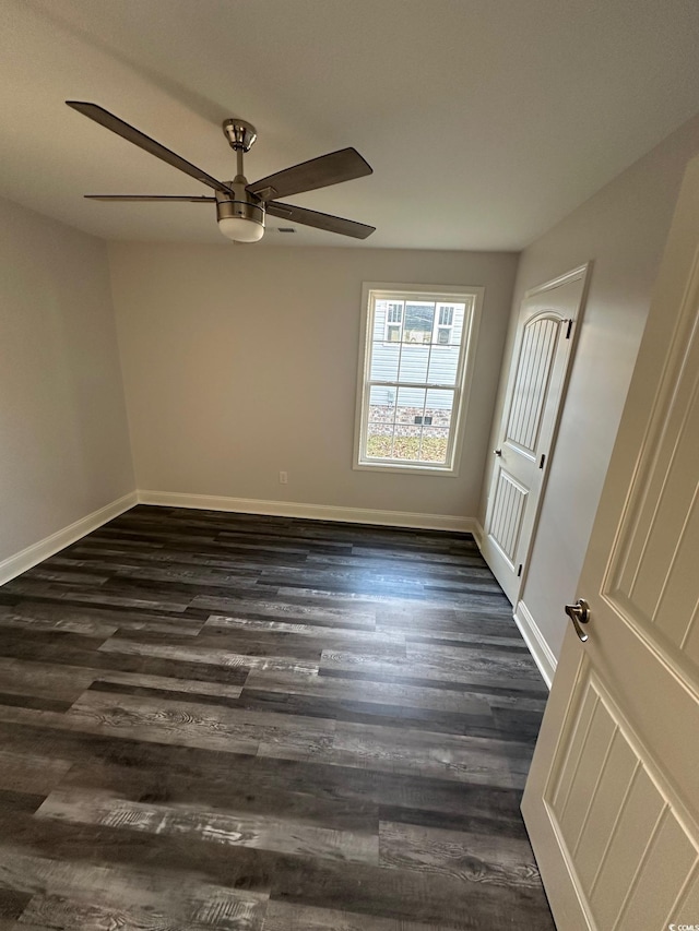 spare room featuring dark hardwood / wood-style flooring and ceiling fan