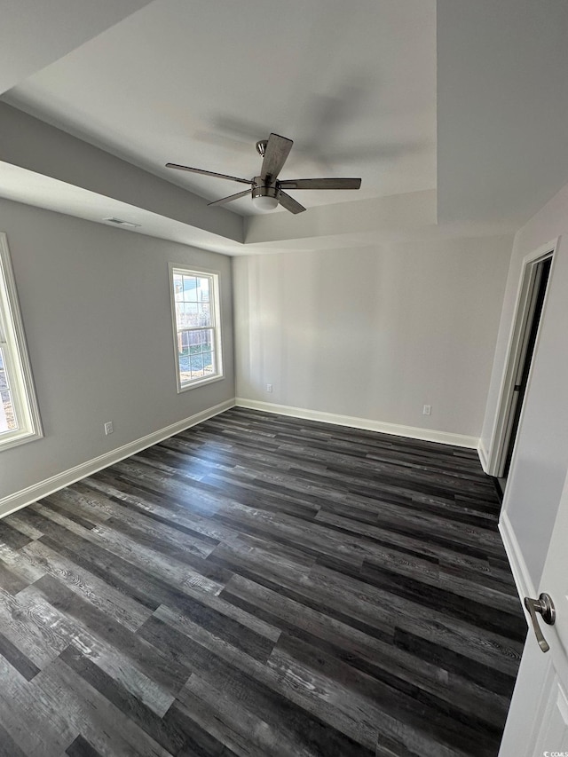 unfurnished room with ceiling fan and dark wood-type flooring