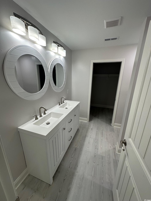 bathroom with vanity and wood-type flooring