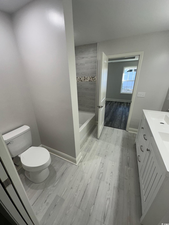 bathroom featuring hardwood / wood-style flooring, vanity, and toilet