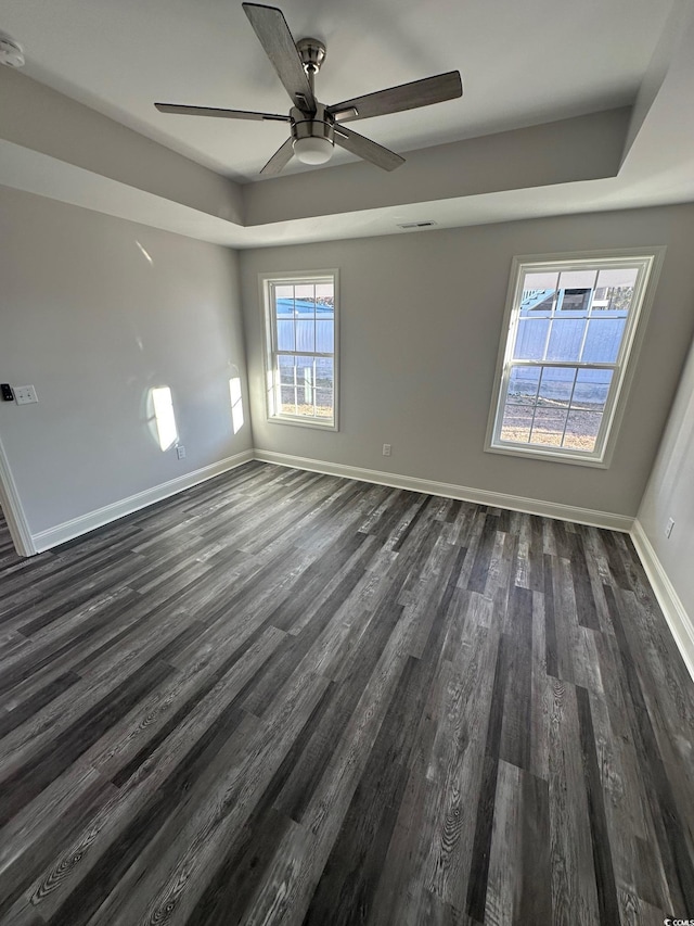 empty room featuring ceiling fan and dark wood-type flooring