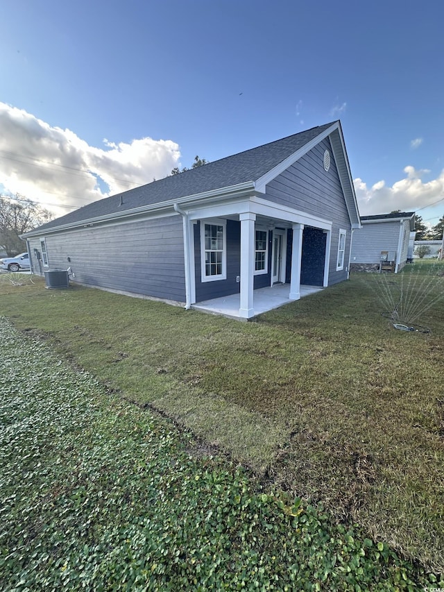 back of house featuring a yard, a patio, and central AC unit