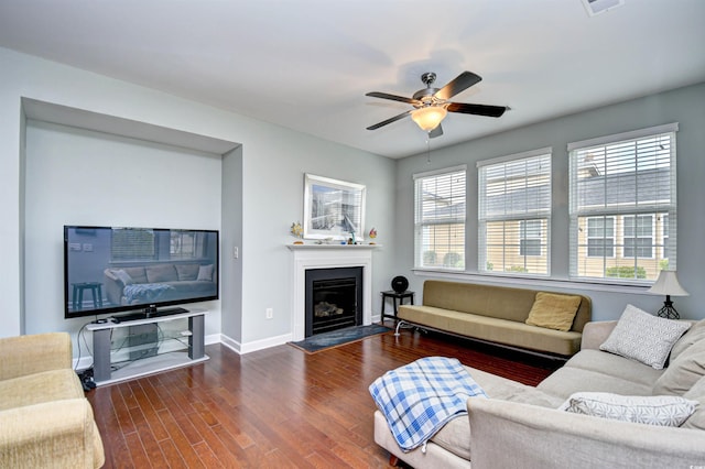 living room featuring ceiling fan and dark hardwood / wood-style floors