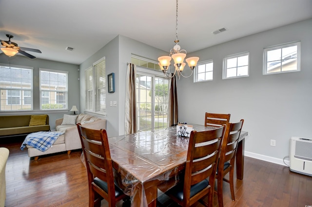 dining room featuring ceiling fan with notable chandelier and dark hardwood / wood-style flooring