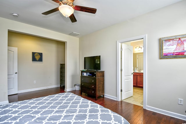 bedroom featuring ceiling fan, wood-type flooring, and ensuite bath