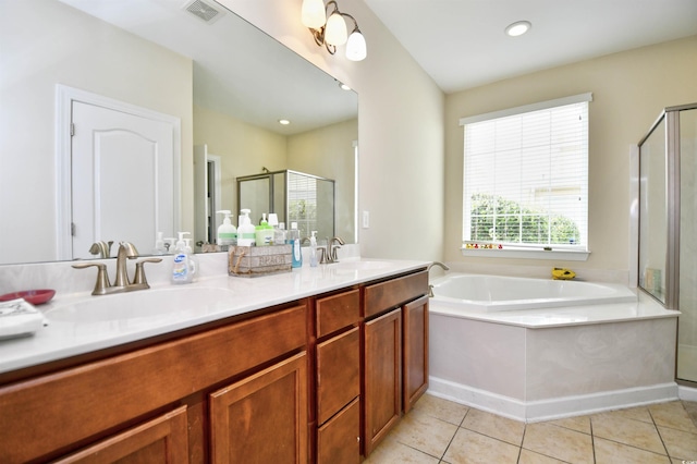 bathroom featuring vanity, independent shower and bath, and tile patterned flooring