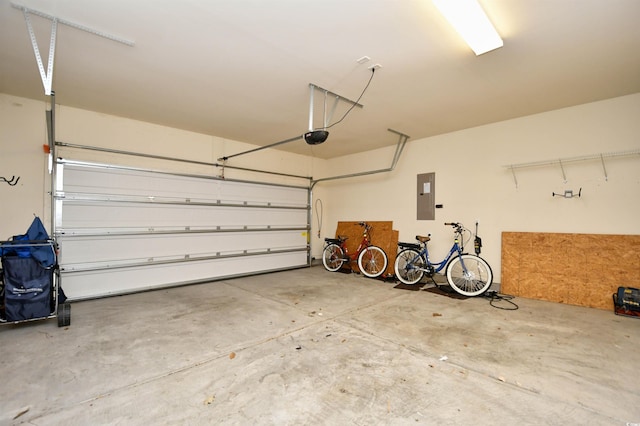 garage with a garage door opener and electric panel