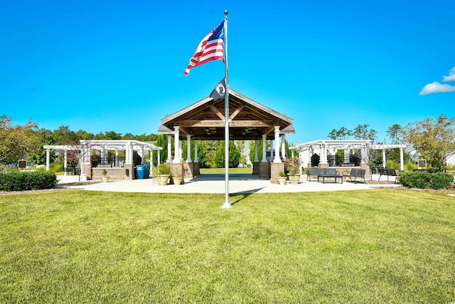 back of property with a gazebo, a patio area, a lawn, and a pergola