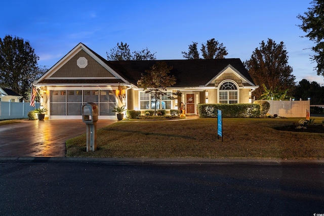 view of front of house with a garage and a lawn