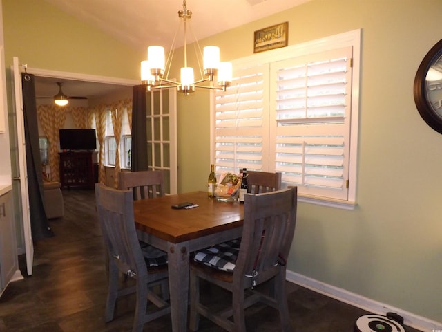 dining space with ceiling fan with notable chandelier and vaulted ceiling