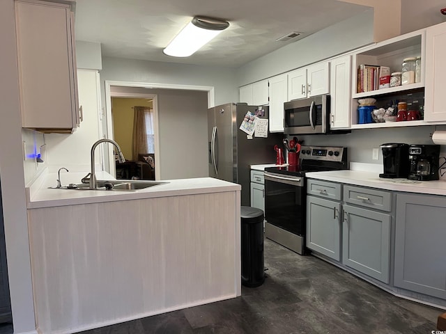 kitchen featuring gray cabinets, sink, and appliances with stainless steel finishes