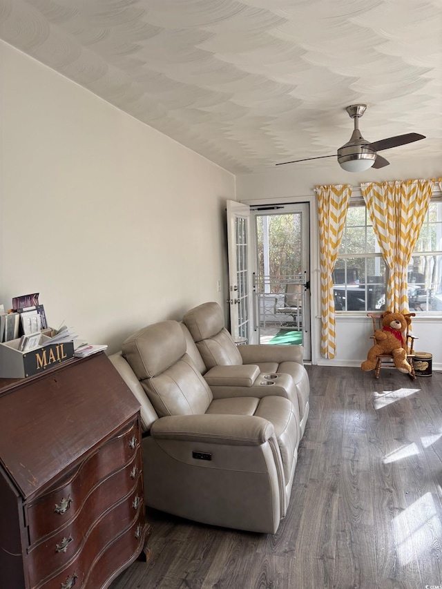 living room featuring ceiling fan and hardwood / wood-style flooring