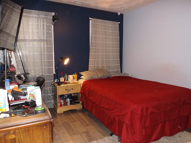 bedroom with hardwood / wood-style flooring