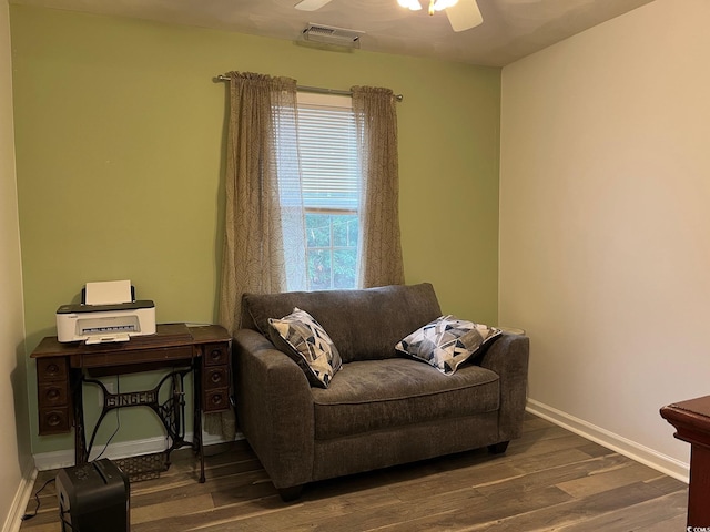 living area featuring ceiling fan and dark hardwood / wood-style floors