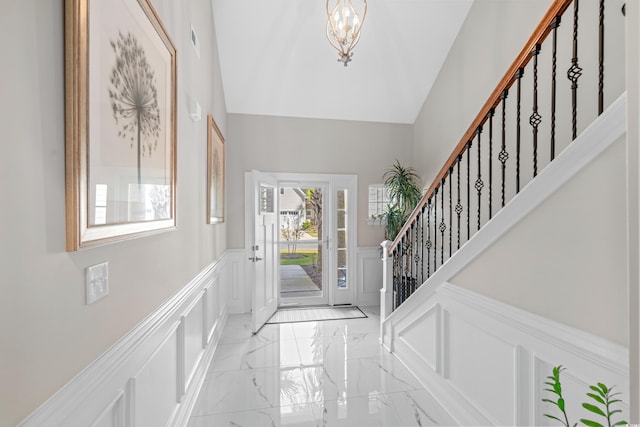 entryway with a notable chandelier and high vaulted ceiling