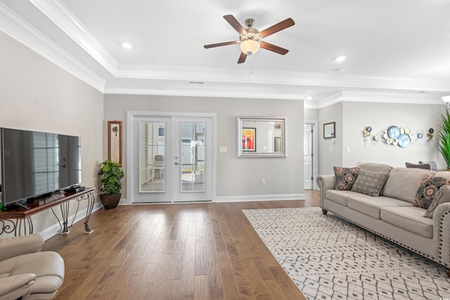 living room featuring crown molding, hardwood / wood-style floors, and ceiling fan