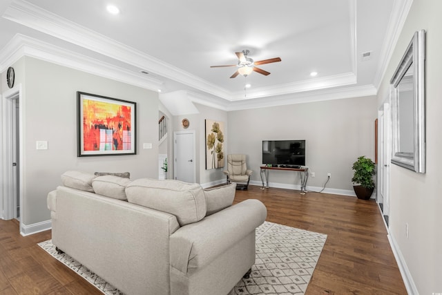 living room with ornamental molding, dark hardwood / wood-style floors, and ceiling fan