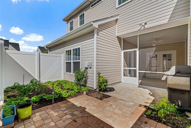 view of patio with area for grilling, ceiling fan, and a sunroom