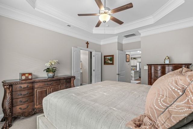 carpeted bedroom featuring crown molding, a raised ceiling, and ceiling fan