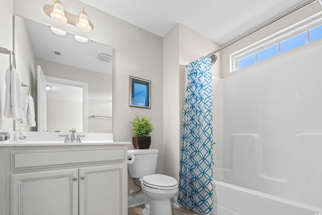 full bathroom featuring vanity, toilet, and shower / bath combination with curtain