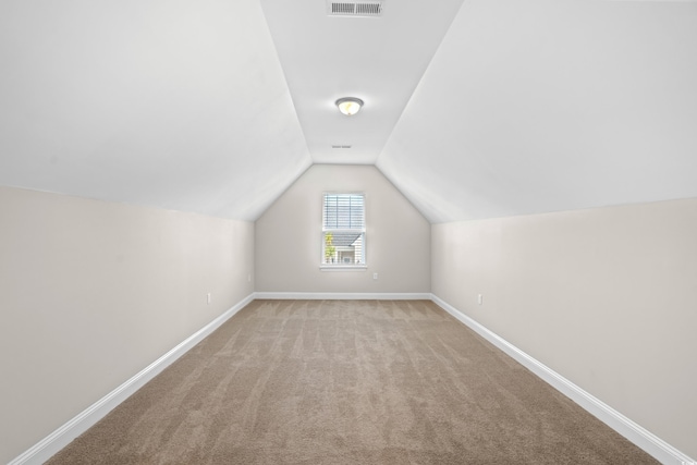 bonus room featuring light carpet and lofted ceiling