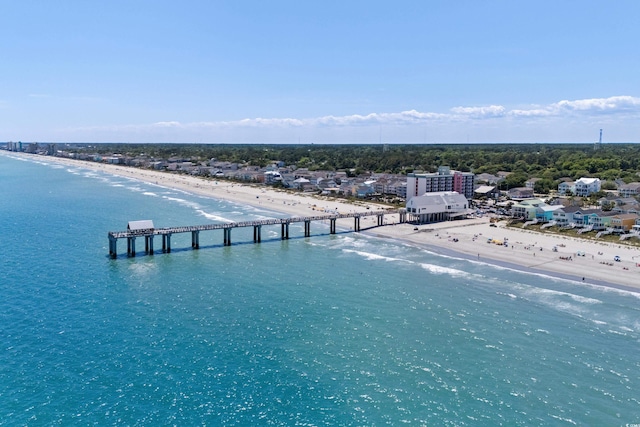 birds eye view of property featuring a water view and a beach view