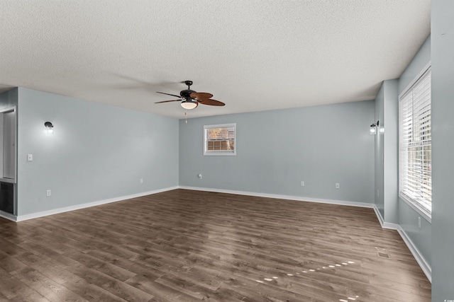 unfurnished room with a textured ceiling, dark hardwood / wood-style floors, and ceiling fan