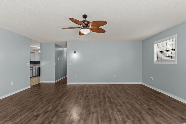 unfurnished living room with ceiling fan, a textured ceiling, and dark hardwood / wood-style floors