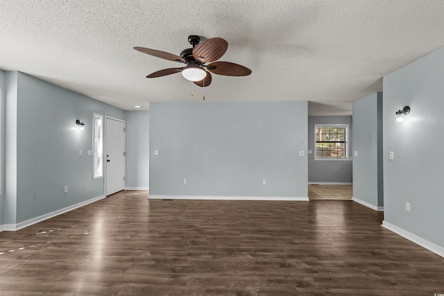 unfurnished living room with ceiling fan, a textured ceiling, and dark hardwood / wood-style floors