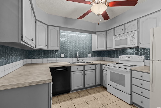 kitchen featuring white appliances, sink, backsplash, gray cabinets, and light tile patterned floors