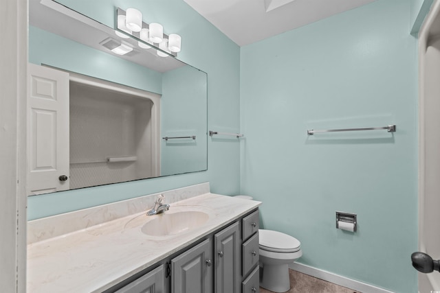 bathroom with vanity, toilet, and tile patterned floors