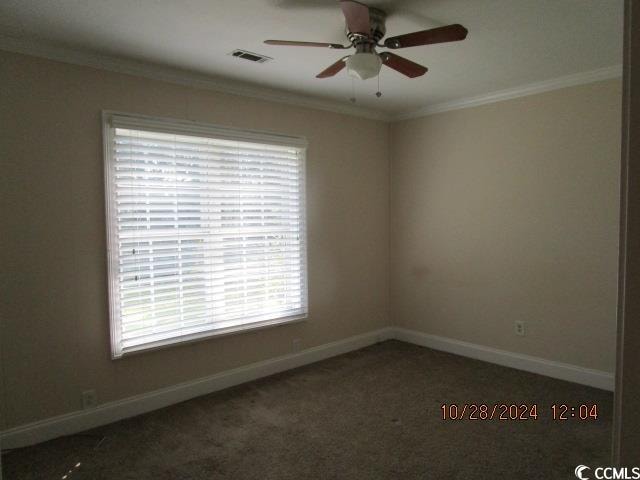 carpeted empty room with ceiling fan and ornamental molding