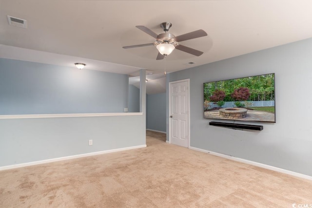 unfurnished room with light colored carpet and ceiling fan